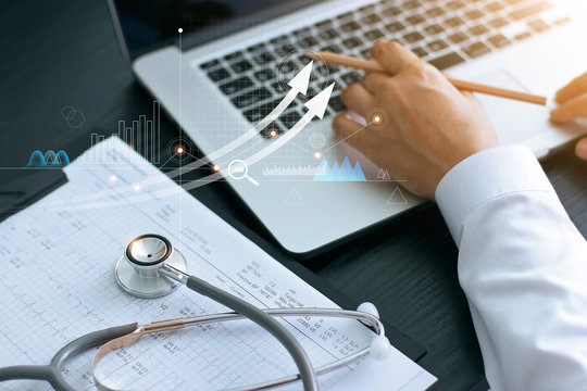 Healthcare Business Graph And Medical Examination And Businessman Analyzing Data And Growth Chart On Laptop Background