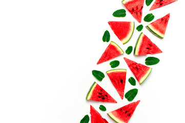 Fototapeta na wymiar Watermelon pattern. Juicy slices of ripe red watermelon and mint leaves on white background. Flat lay, top view, copy space. Creative summer food concept