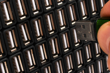 Man inserts USB flash drive in one of many sockets