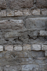 Brick wall with destroyed masonry