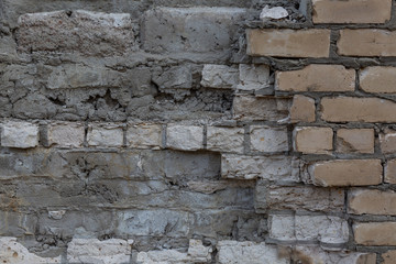 Brick wall with destroyed masonry