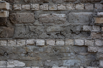 Brick wall with destroyed masonry