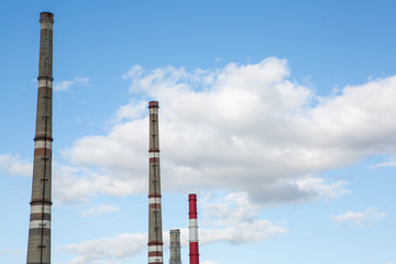 factory chimneys on background of blue sky