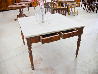 Old italian table just restored in a junk shop with top in white Carrara marble
