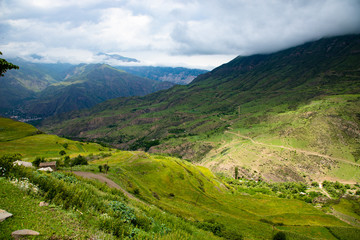 Fototapeta na wymiar Mountain landscape cloudy sky green Alpine meadows in the mountains