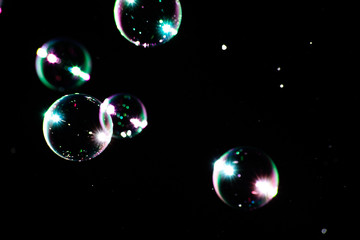 Soap bubbles with highlights on a dark background