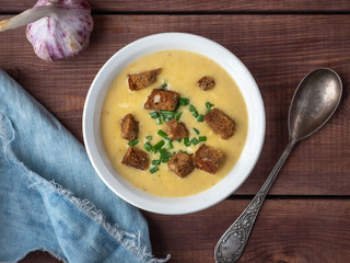 Cheese soup with croutons of dark bread from the top view