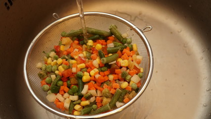 Mix of vegetables. Green asparagus beans, yellow corn, orange carrots, red pepper.