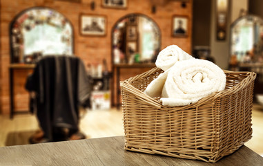 Table background with towels and blurred hairdresser and barber shop view.