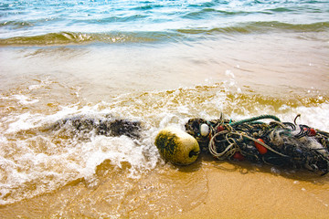 Broken seines or trawls or fishnets lay on the tropical beach in Malaysia