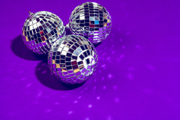 disco ball shines on purple background close up
