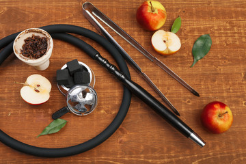 Parts of hookah and fruits on wooden background