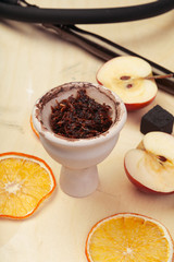 Parts of hookah and fruits on wooden background