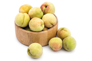 Fresh ripe organic peaches in wooden bowl, Prunus persica, isolated on white background. Vinogradarska breskva. Šeftelija