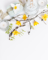 Spa treatment with blooming branch on white background
