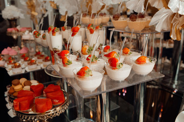 Candy bar. Table with strawberry deserts. Sweet table for banquets, weddings, parties.