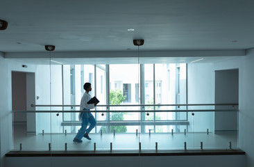 Female doctor running in the corridor at hospital