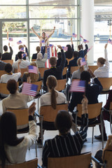 Young businesswoman doing speech and celebrating victory in conference room