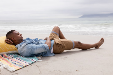 Man sleeping at beach on a sunny day