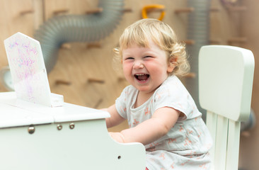 A small girl playing toy piano