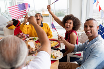 Multi-generation family celebrating US Independence day on a dining table