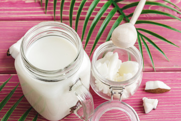 Coconut butter on wooden background. Organic healthy food concept