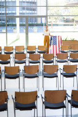 Young Caucasian female executive looking at digital tablet in empty conference room