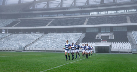 Group of male rugby players entering stadium in a row for match