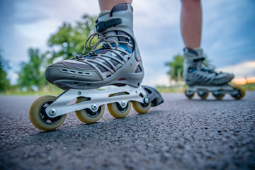 roller skates in action on the asphalt trail at freestyle races outside the city