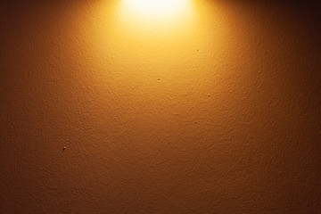 Bright spot of sconce lamp on the wall