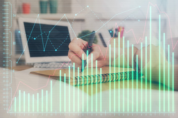 Financial graph displayed on woman's hand taking notes background. Concept of research. Double exposure