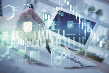 Financial forex graph drawn over hands taking notes background. Concept of research. Multi exposure