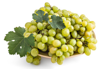Fresh ripe white grapes with leaves on wooden plate isolated on a white