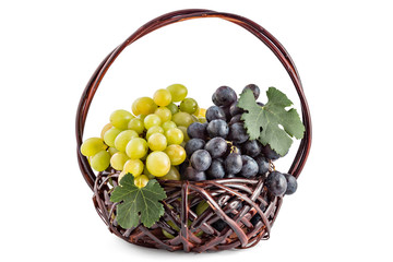 Ripe red and green grapes in the old wooden basket isolated on a white