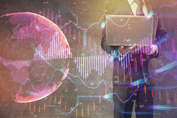 Forex graph with businessman working on laptop on background. Concept of hardworking. Multi exposure.