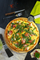 Appetizing pizza with bacon, cheese and herbs