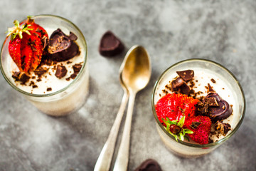 Dessert Vanilla panna cotta with fresh berries and chocolate  on gray background,.Top view. Holiday and comfort food concept