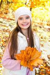 Autumn portrait of adorable smiling  little girl child with leaves