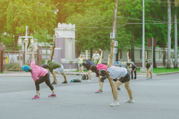Group of elderly friend doing aerobic dance after work   together at Lumpini Park in Bangkok,...