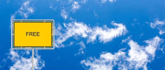 yellow road sign with FREE on blue sky