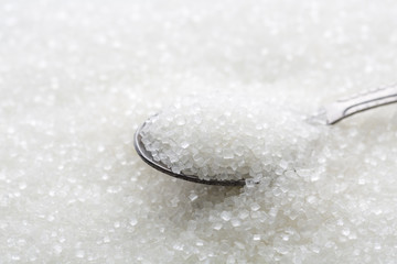 Closeup of spoon with white sugar