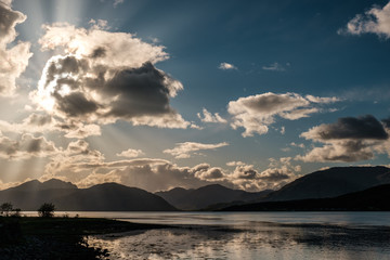 Sun rays filtering through clouds over Loch Linnhe in Scotland