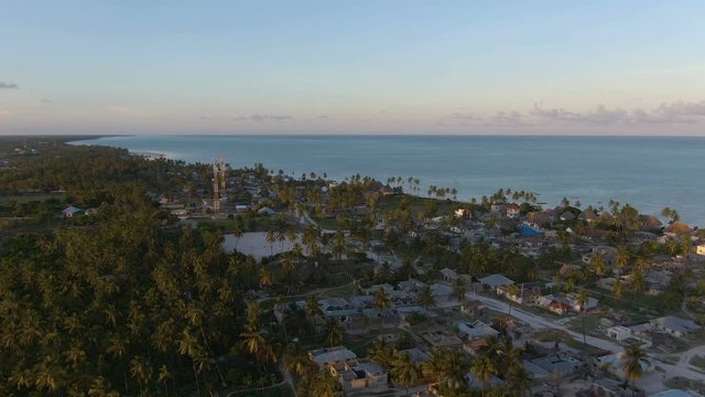 Flying above luxury bungalows on exotic Zanzibar island on sunset