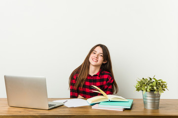 Young teenager going back to her routine doing homeworks laughing and having fun.