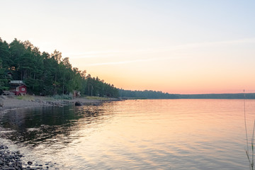 Obraz premium Finland, northern Europe, the rocky shore of the lake. Sunset and natural landscape