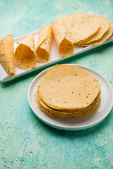 Gujarati papad or papadum in raw dried form with roasted cone, roll and flat variation