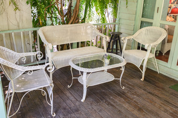 Antique weaving chairs with table on wood patio