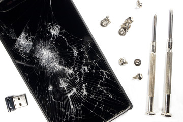 broken smartphone and screwdriver for repair on white background, isolated