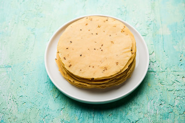 Gujarati papad or papadum in raw dried form with roasted cone, roll and flat variation