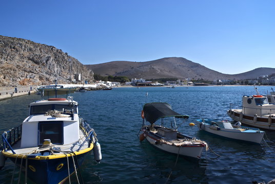 Greece, the island of Pserimos in the Dodecanese.  The harbor before the day trip boats arrive.  Moored fishing boats.